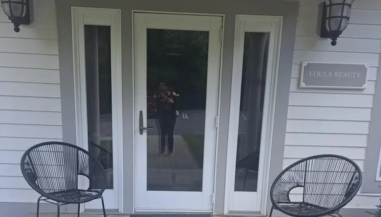 Front entrance at 1 Hunter Ave, Armonk, NY: the door marked with the LOULA BEAUTY sign, where clients enter to reach Glow Fusion Esthetic